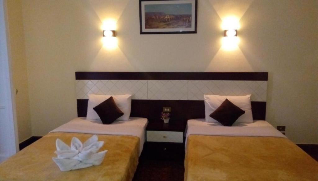 Postel nebo postele na pokoji v ubytování Cairo Paradise Hotel