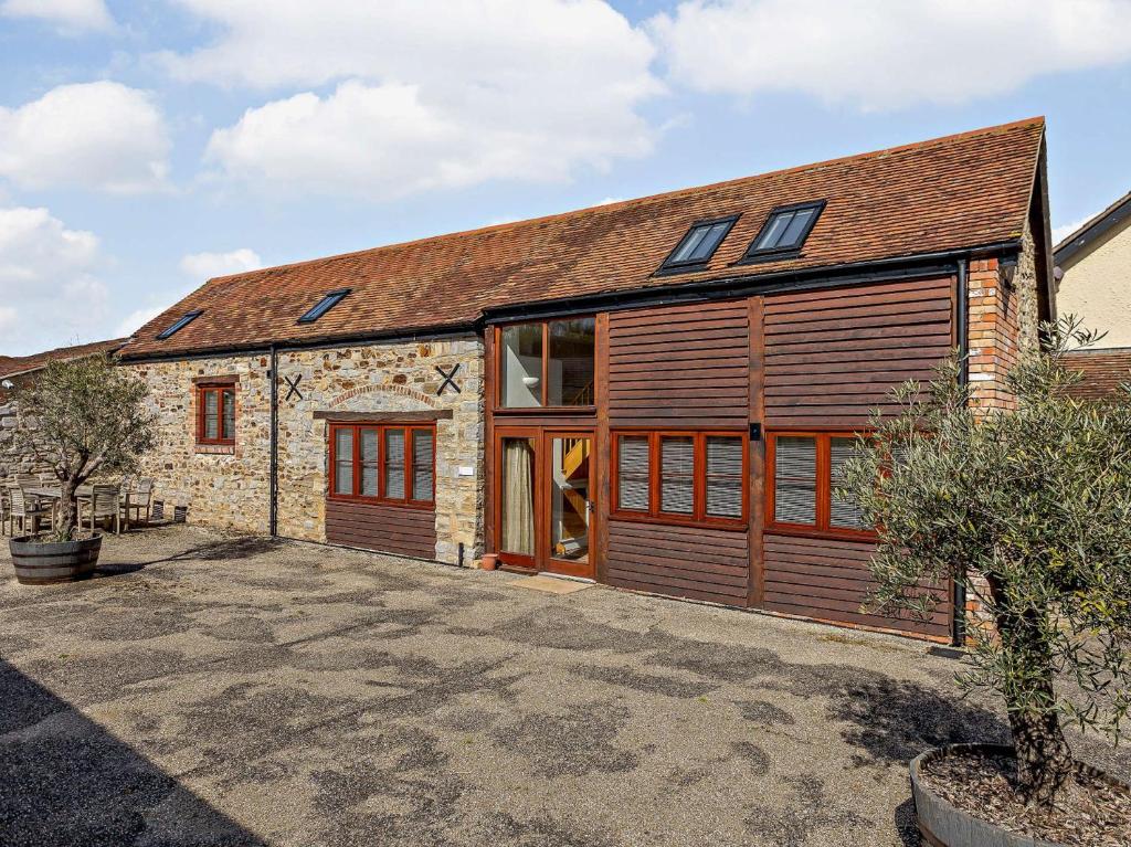 an old stone house with wooden garage doors at 3 bed in Taunton KIBOR in Trull