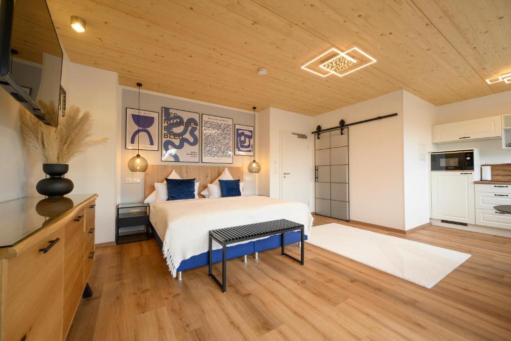 a bedroom with a bed and a kitchen at Landgasthof zur Sonne in Dillingen an der Donau