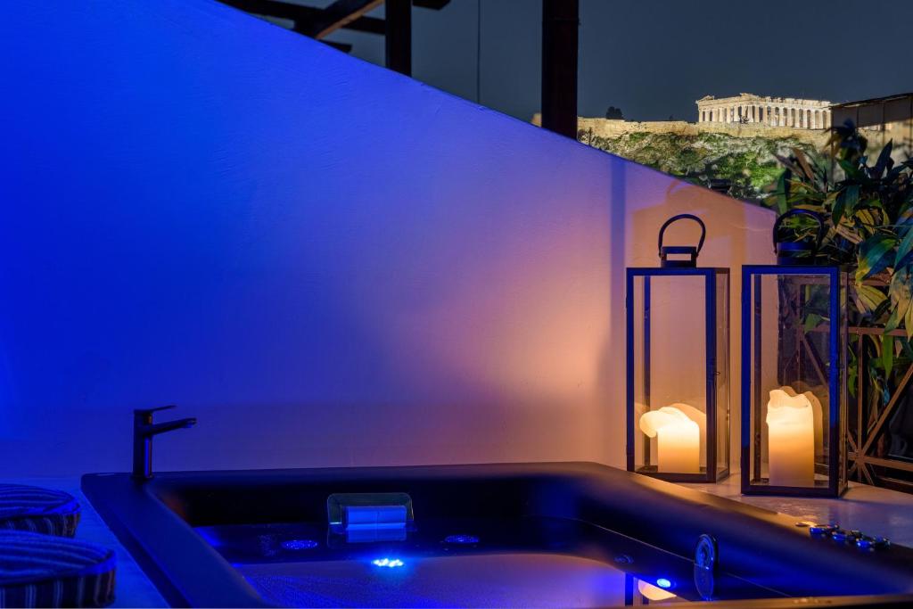 ein Badezimmer mit einer Badewanne mit blauem Licht in der Unterkunft Penthouse W/ View & Plunge Pool in Athen