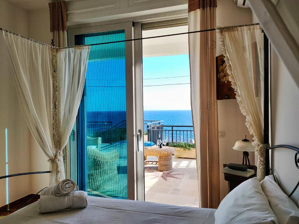a bedroom with a bed and a view of the ocean at The Lookout in Marina Porto