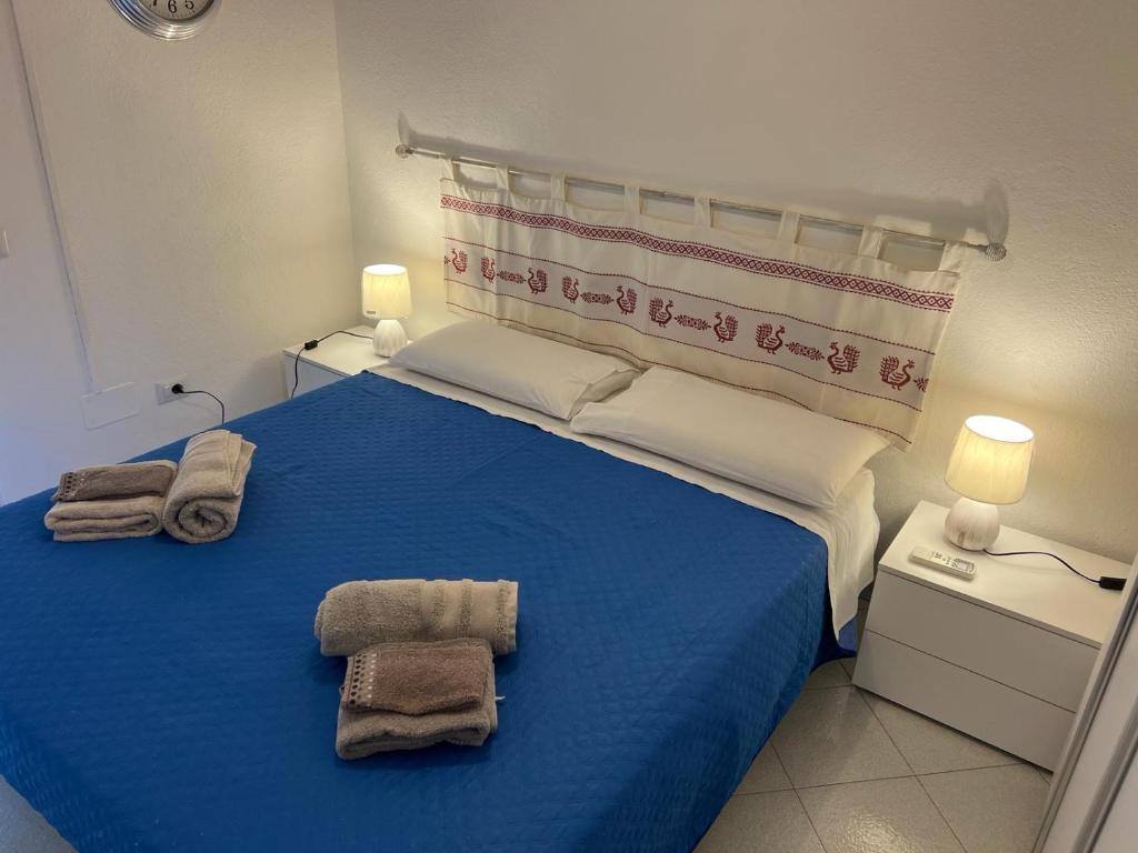 En eller flere senge i et værelse på Mare Smeraldo Appartamento