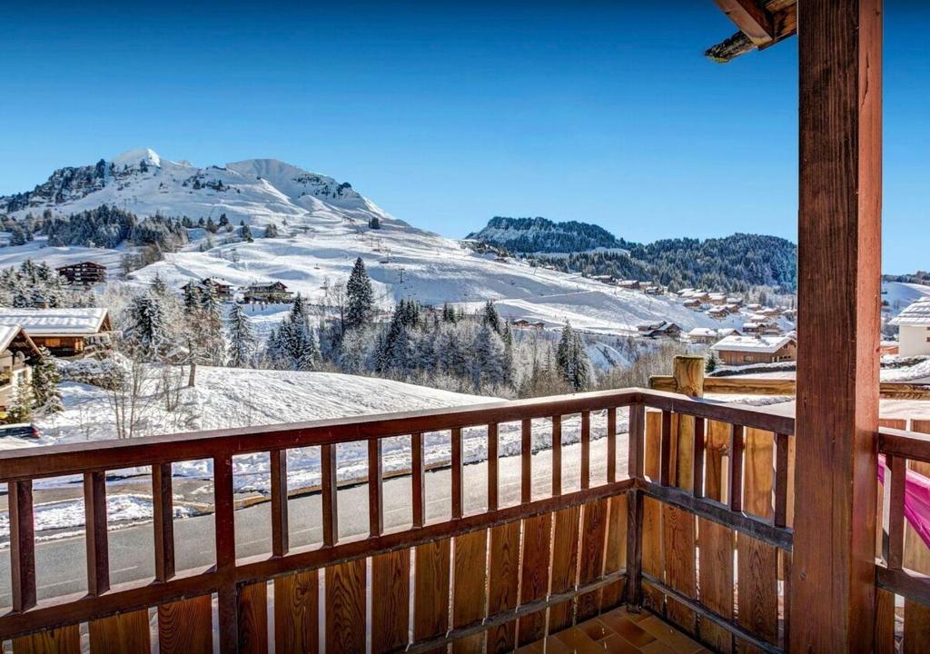 a balcony with a view of a snow covered mountain at Chalet Sicoria - Les Congères in Le Grand-Bornand