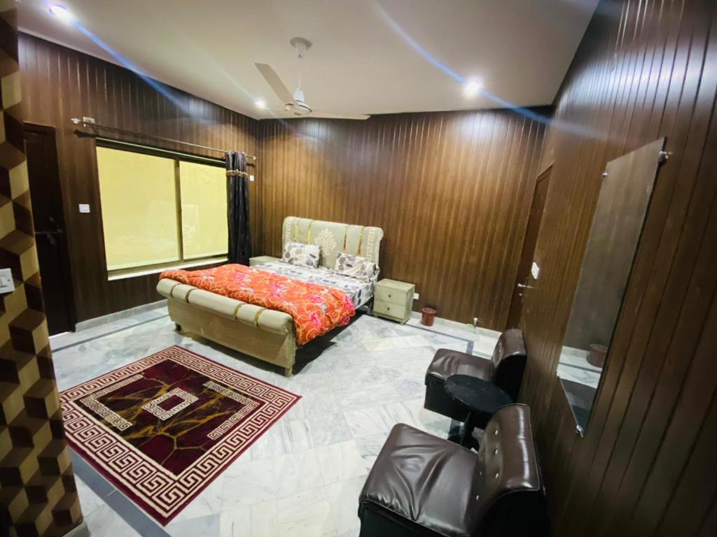 a bedroom with a bed and a couch in a room at Kashee's Lodges in Islamabad