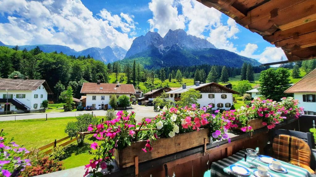 a view of a village with flowers on a balcony at Ferienwohnung Alpspitze in Grainau