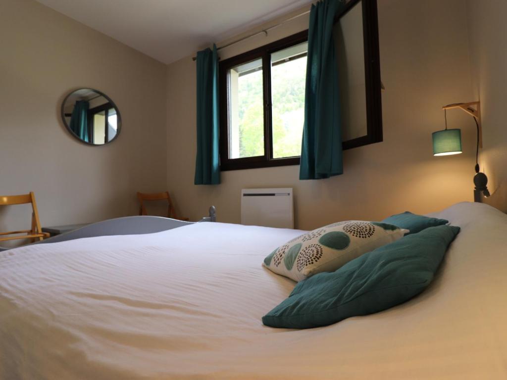 a bedroom with a bed with two pillows on it at Appartement Annecy, 3 pièces, 6 personnes - FR-1-432-4 in Annecy