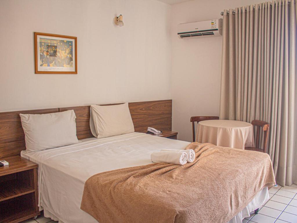 Postel nebo postele na pokoji v ubytování Sunshine Praia Hotel