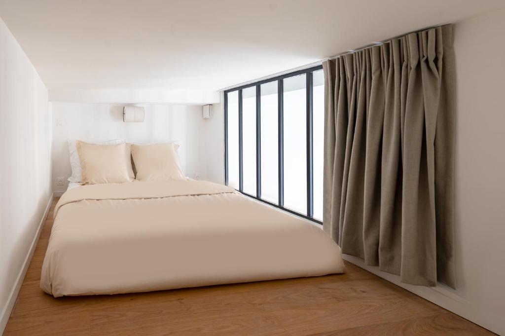a bedroom with two beds and a window at Noble Suites in Paris