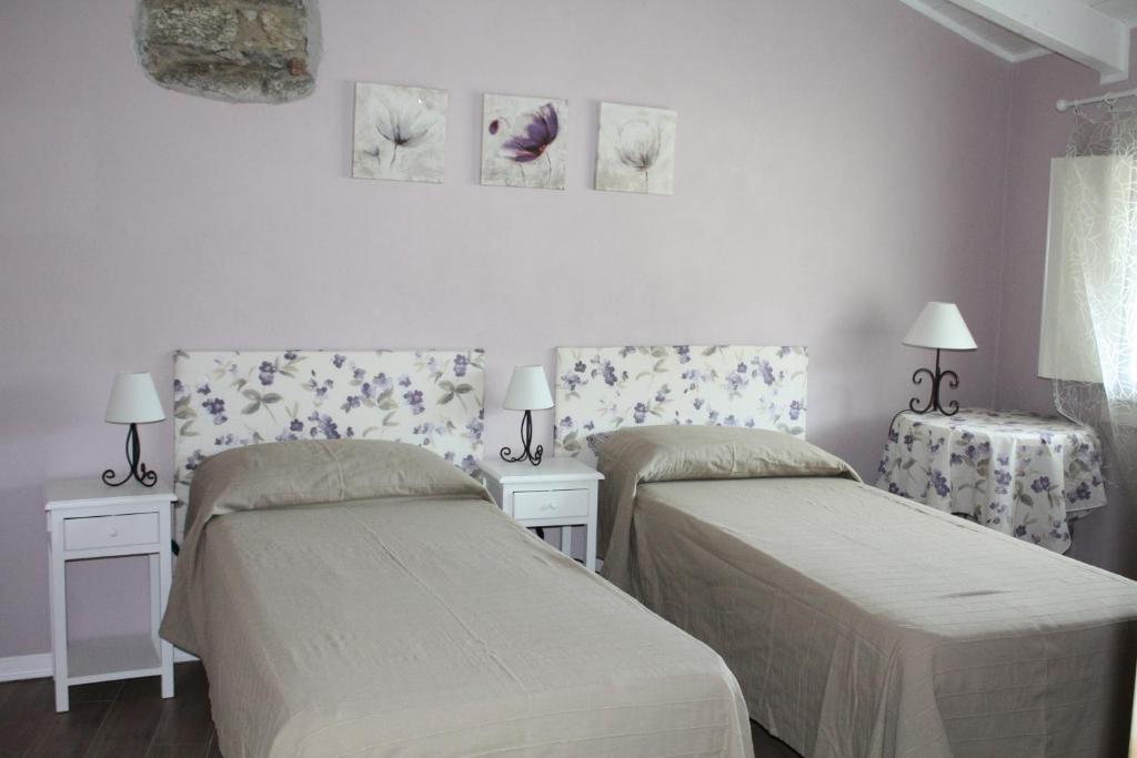 A bed or beds in a room at Il Cortile Friendly House