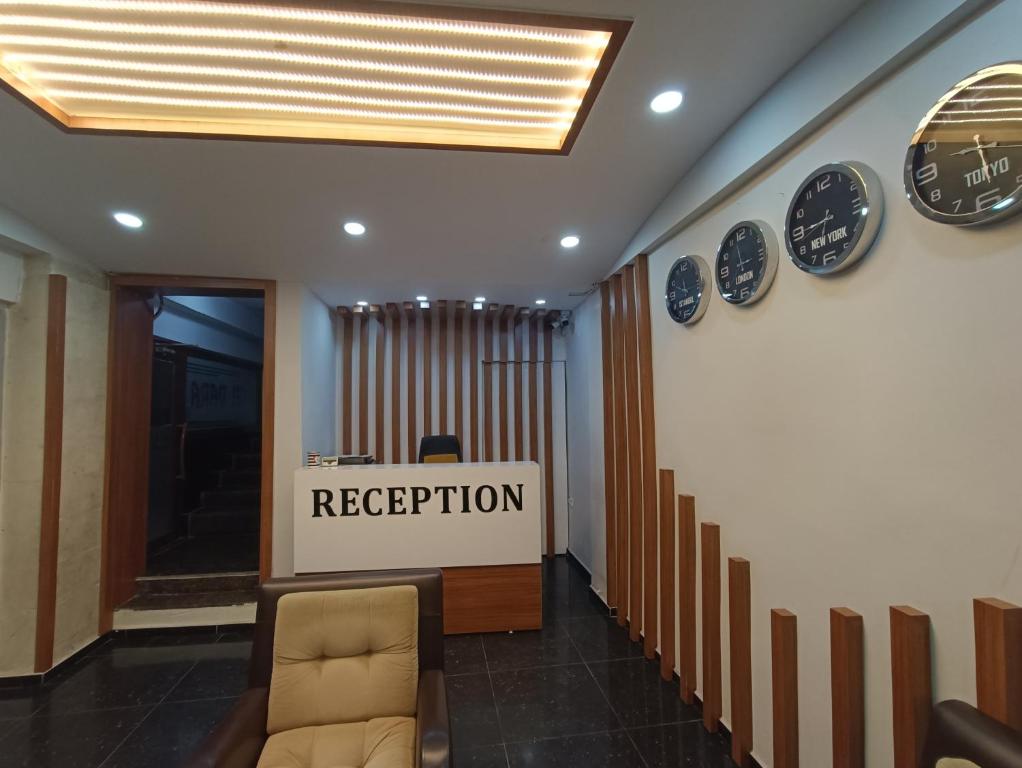 a lobby with a reception sign and clocks on the wall at dara otel in Midyat