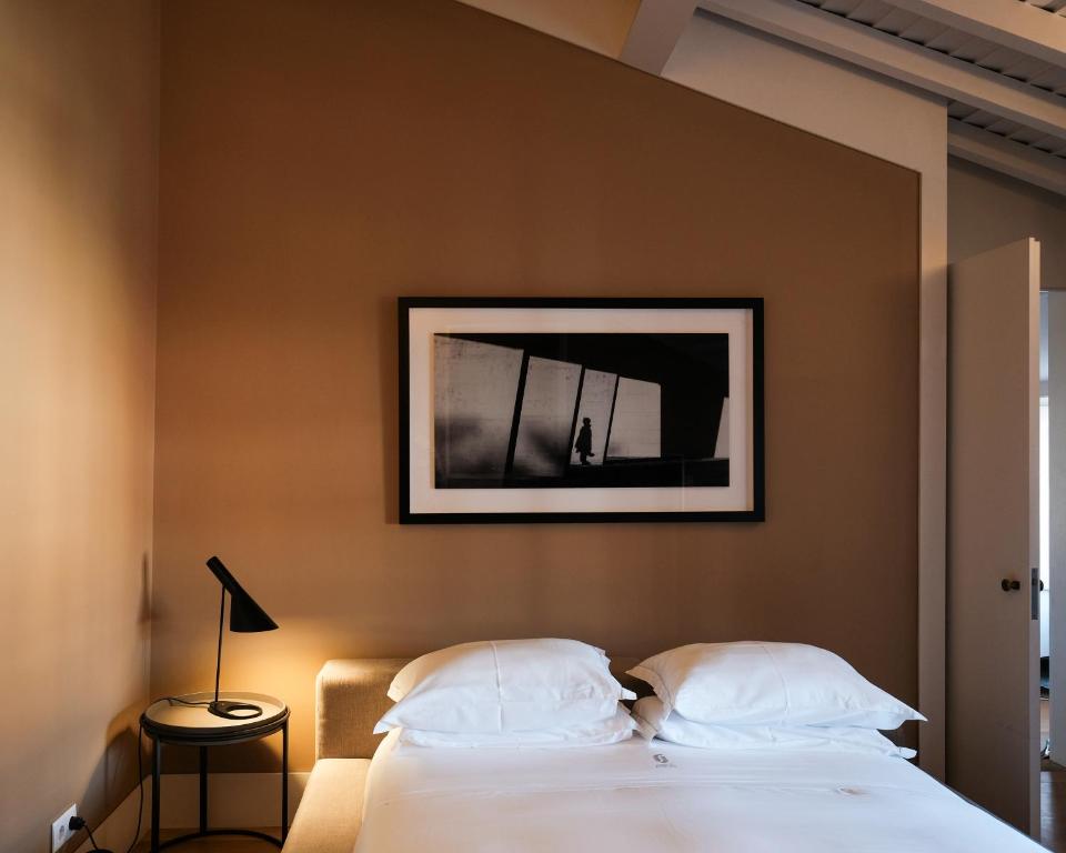 een slaapkamer met een bed met een foto aan de muur bij Casa do Juncal in Guimarães