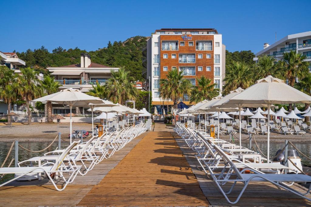 a row of chairs and umbrellas on a dock at Cettia Beach Resort in Marmaris