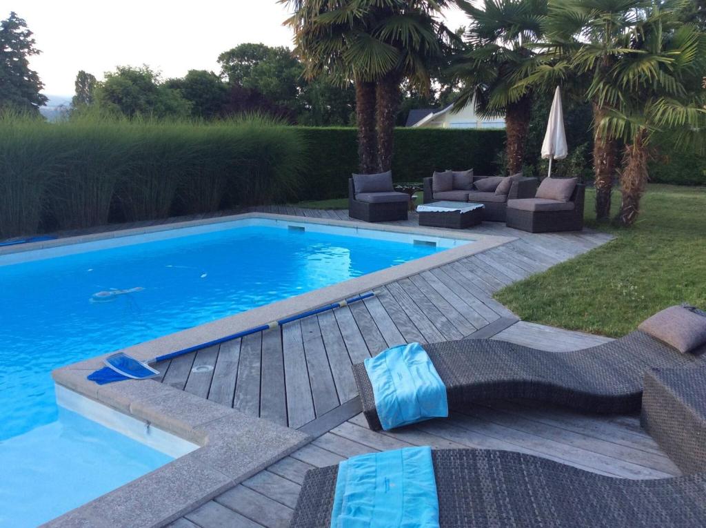 a swimming pool in a yard with lounge chairs at Modern Villa With Swimming Pool Lake Access in Nernier