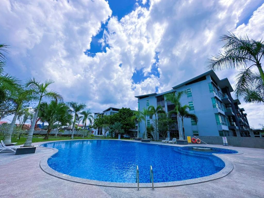 a large swimming pool in front of a building at Doyar's Home Stay (Palm Garden -1st Floor) in Lahad Datu