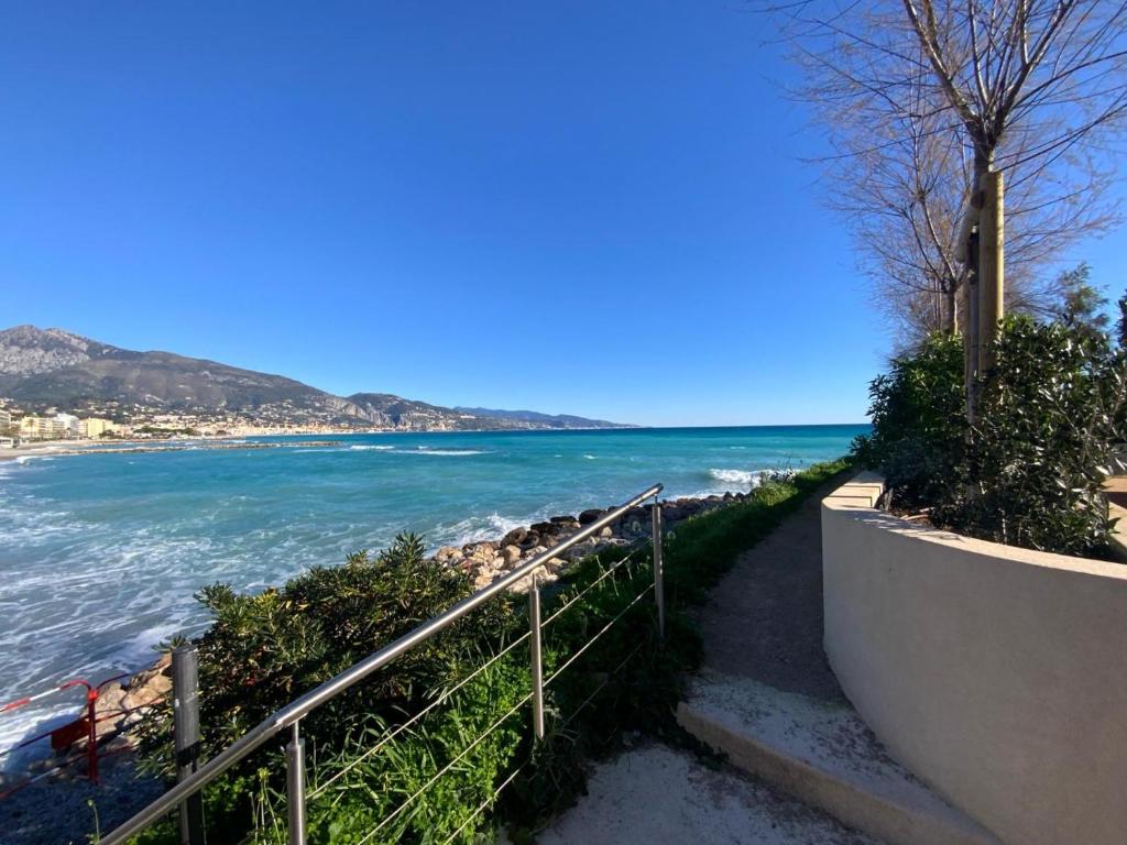 a stairway leading down to a beach with the ocean at Andrea's holydays in Roquebrune-Cap-Martin