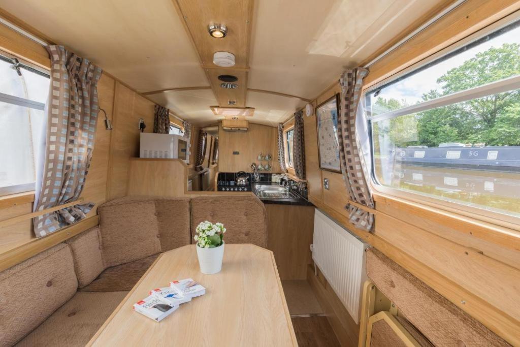 Habitación pequeña con mesa en un vagón de tren en Wren Class at Gayton Marina en Northampton