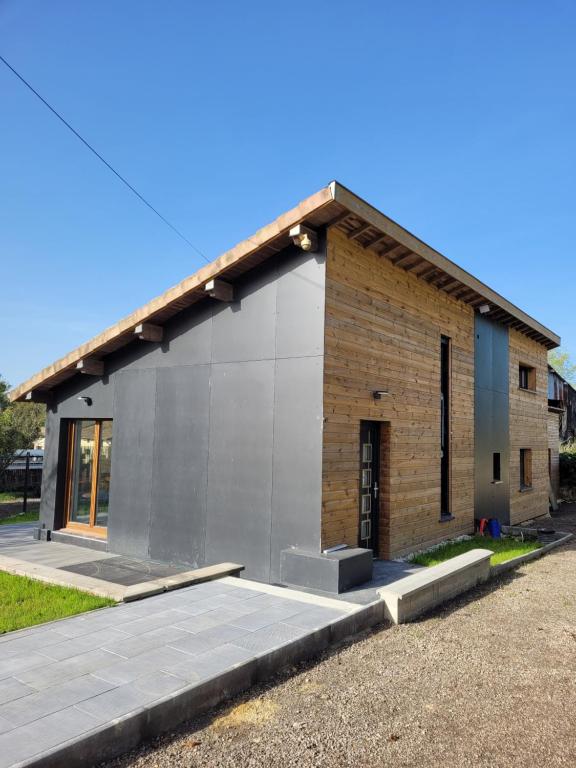 a small brick building with a garage at Maison proche de Verdun, en campagne, jusqu'à 6 personnes in Lemmes