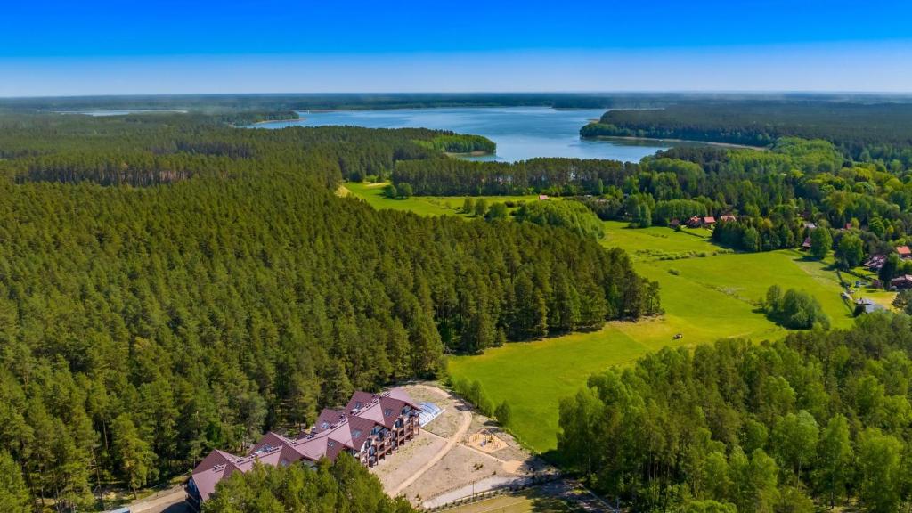 an aerial view of a golf course with a lake at Zapach Lasu - Naturalne SPA, Sun & Snow in Karwica