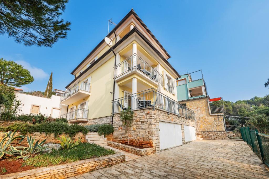 an exterior view of a house with a driveway at Villa K&K in Rovinj
