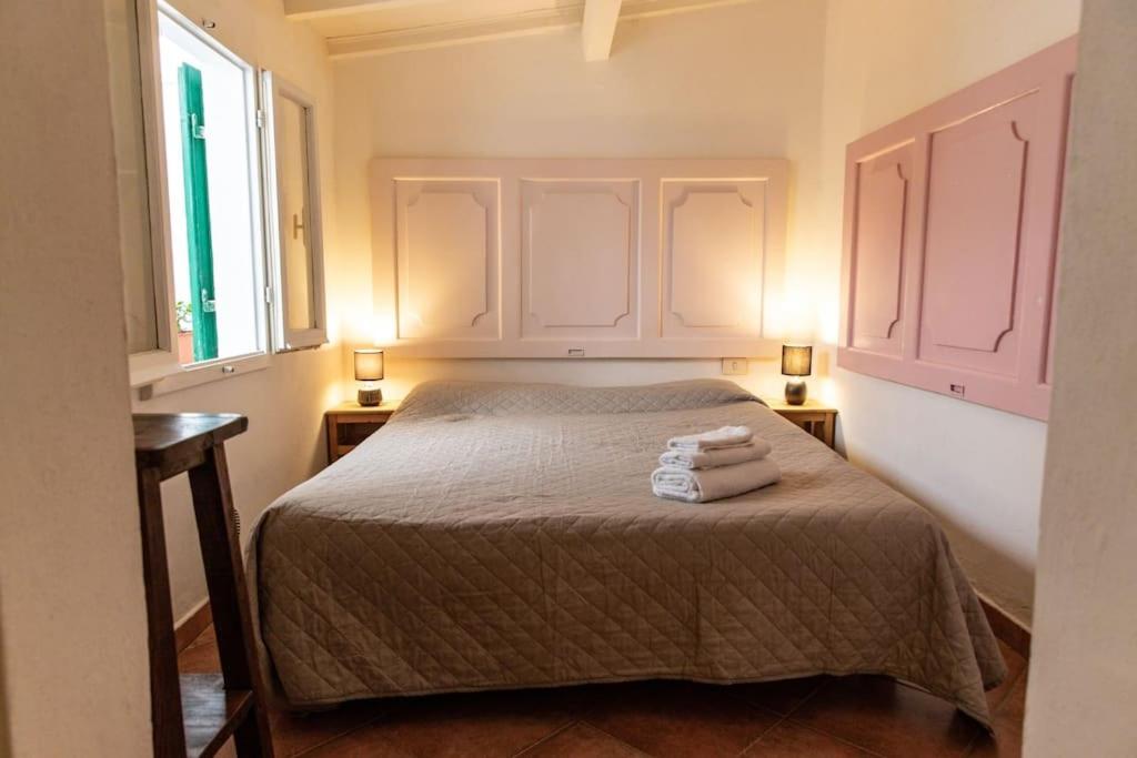 a bedroom with a bed with two towels on it at In the small heart of Florence + Corte privata+ WiFi+AC in Florence