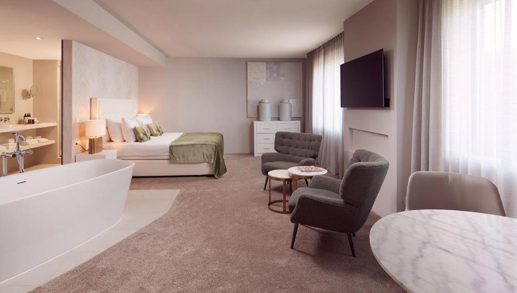 ein Hotelzimmer mit einem Bett und einem Bad in der Unterkunft Van der Valk Hotel Amersfoort-A1 in Amersfoort
