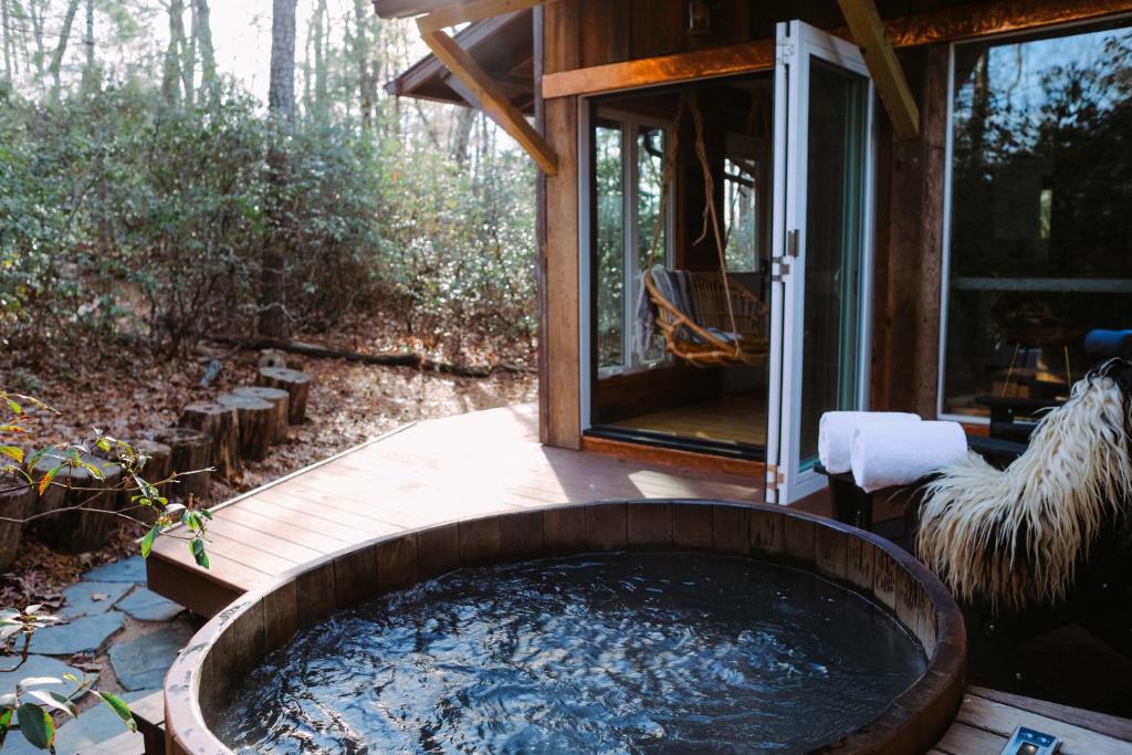 a hot tub in the backyard of a house at The Forest Bathhouse - Sauna, Soak, & Luxury in Fairview