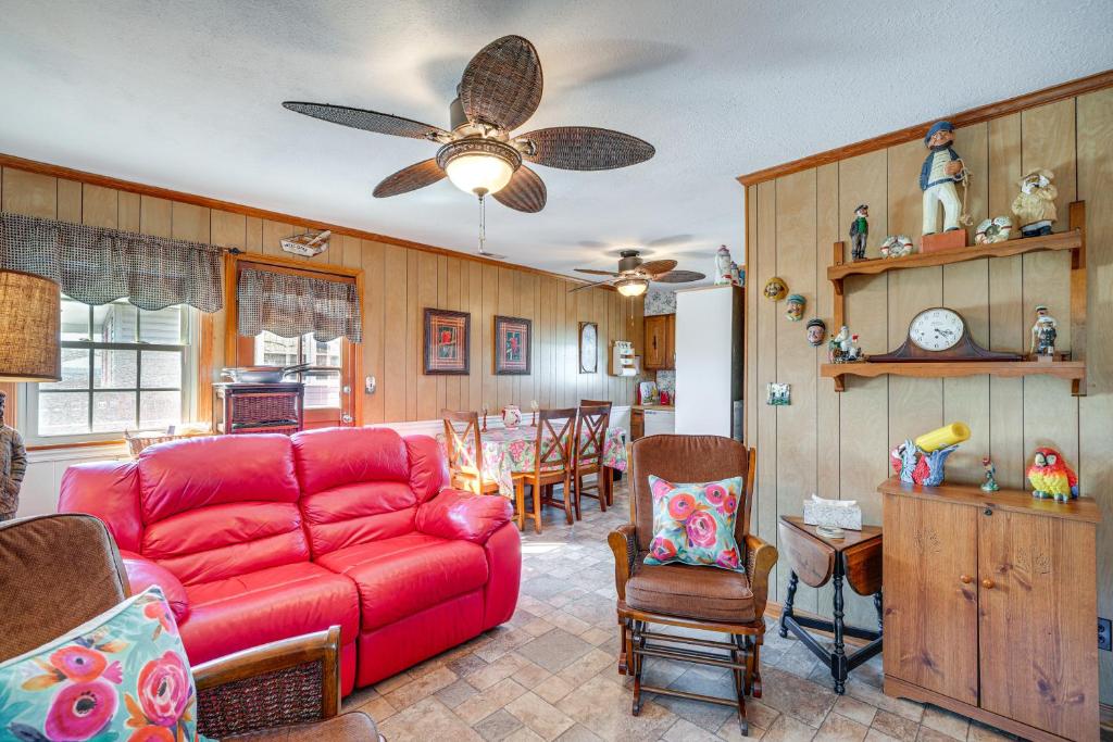 a living room with a red couch and chairs at Kill Devil Hills Vacation Rental, Walk to Beach! in Kill Devil Hills