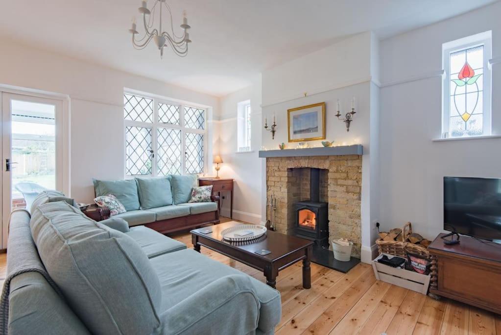 a living room with a couch and a fireplace at Yew Tree Cottage in Margate