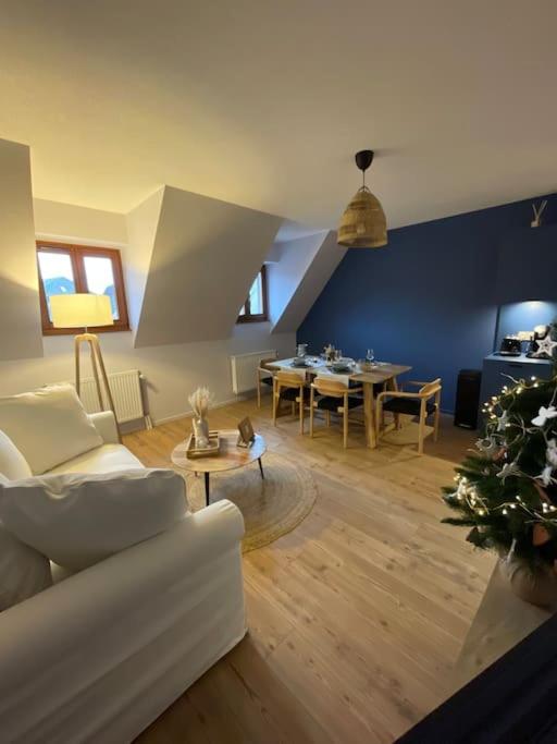 un salon avec un canapé blanc et une table dans l'établissement Le P'tit Bretzel, à Turckheim