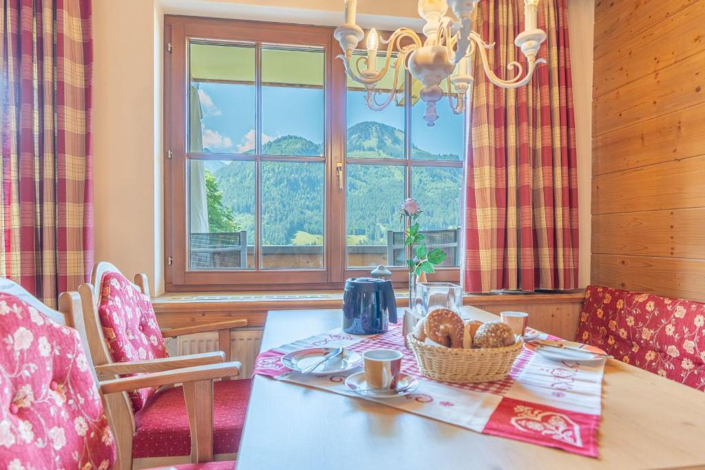 a dining room with a table and a window at Landhaus Schenk Rotspitze in Bad Hindelang