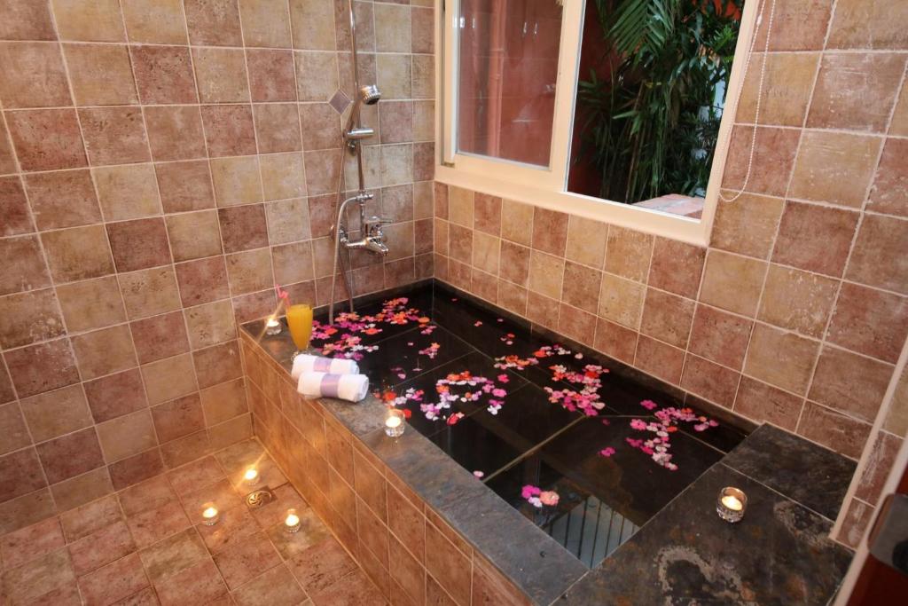 a shower with a bathtub with flowers in it at Xin Yuan My Dream Castle in Dongshan