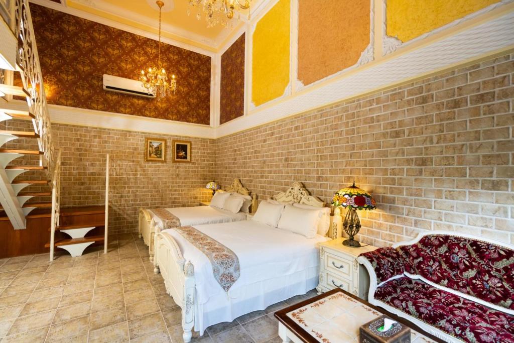 a bedroom with two beds and a brick wall at Xin Yuan My Dream Castle in Dongshan