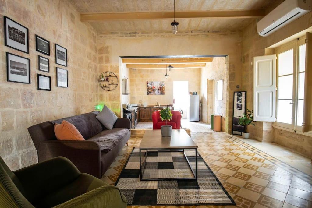 a living room with a couch and a table at Chic, Stylish & Spacious flat in central Valletta in Valletta