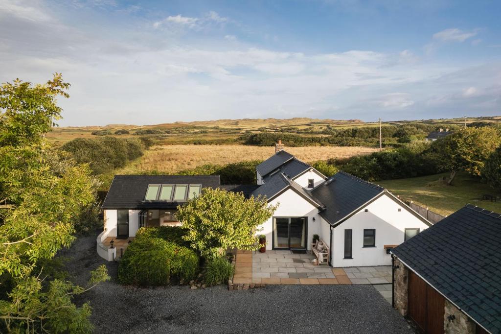 an aerial view of a white house at Lower Mill - 3 Bedroom - 5* Retreat - Llangennith in Llangennith