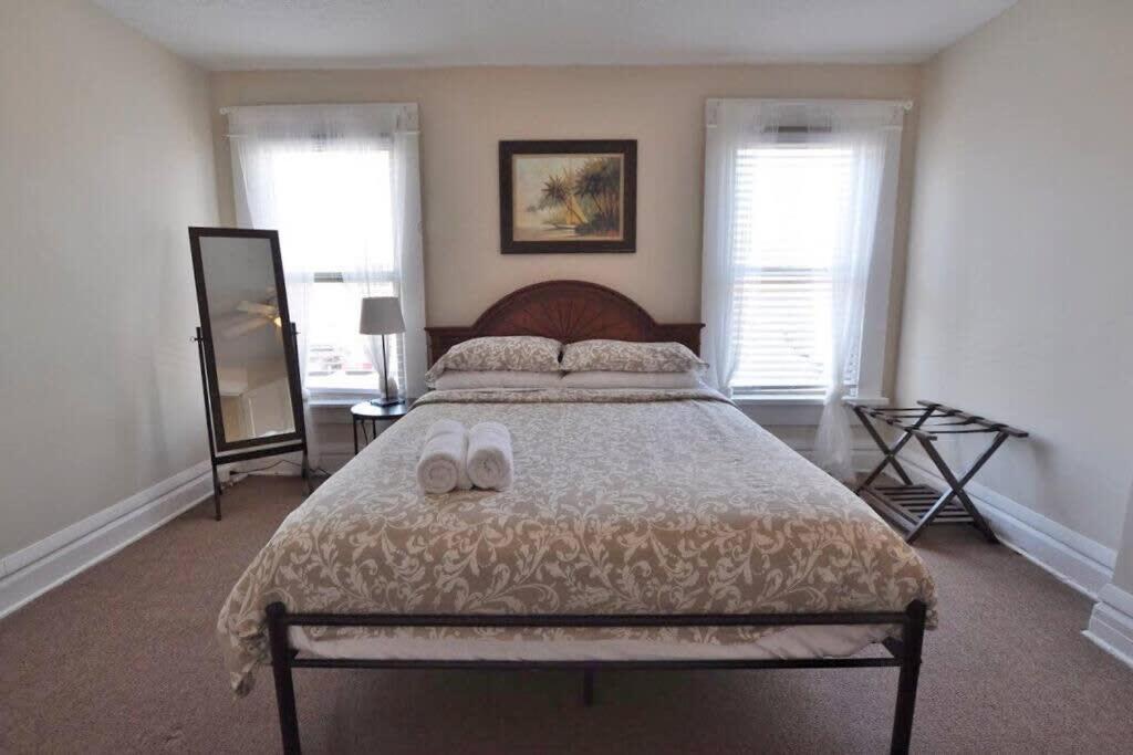 a bedroom with a bed with two slippers on it at Housepitality - The Traveler's Townhouse in Columbus