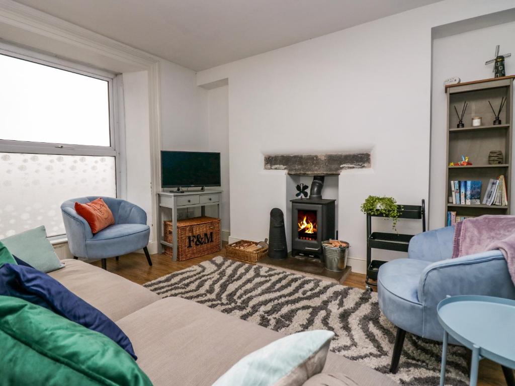 a living room with a couch and a fireplace at 7 New Street in Sedbergh