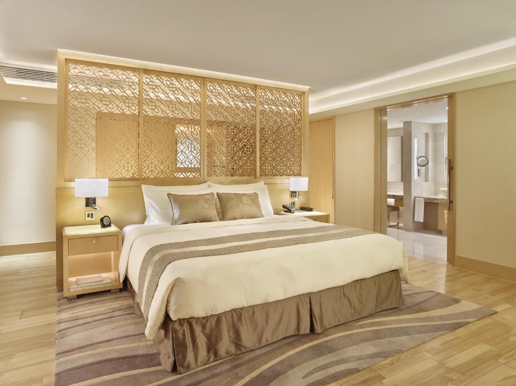 a large bedroom with a large bed and two lamps at White Swan Hotel in Guangzhou