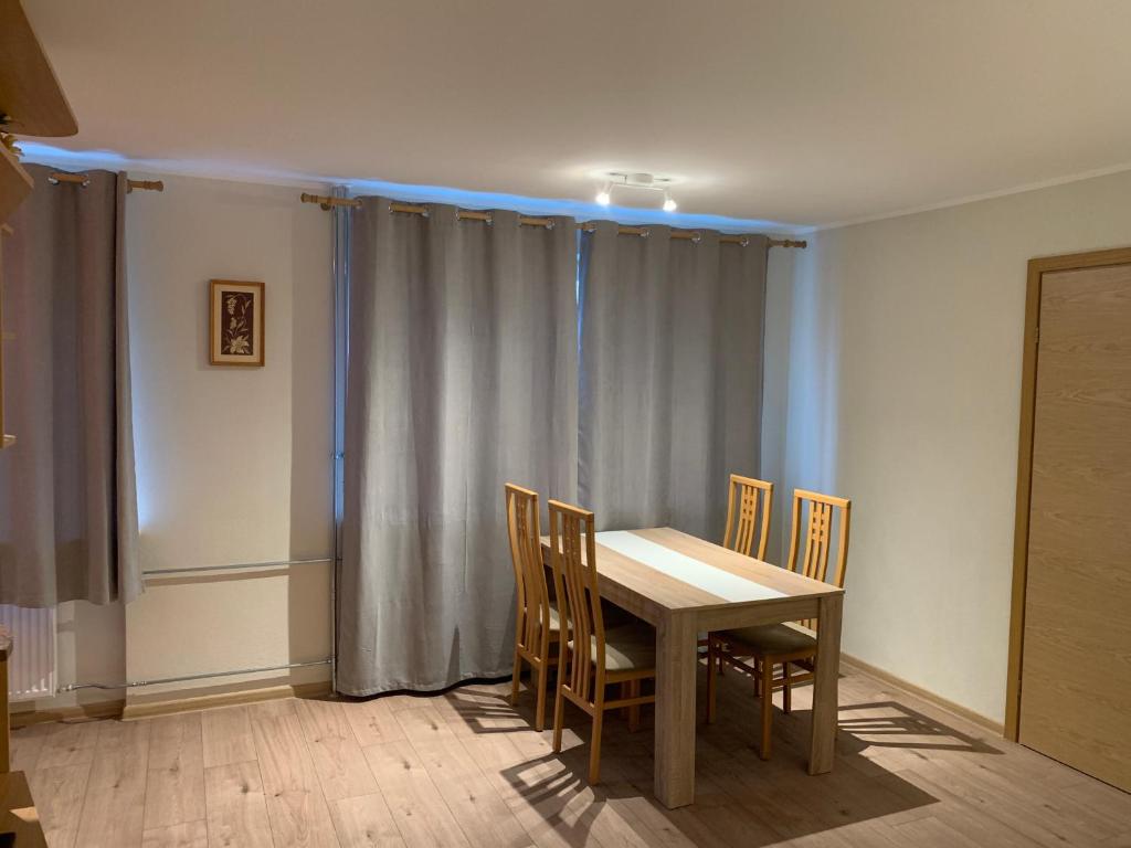 a dining room with a table and chairs at DIKOL Two-Room Apartment-SELF CHECK-in & FREE Parking Near City Center in Tallinn