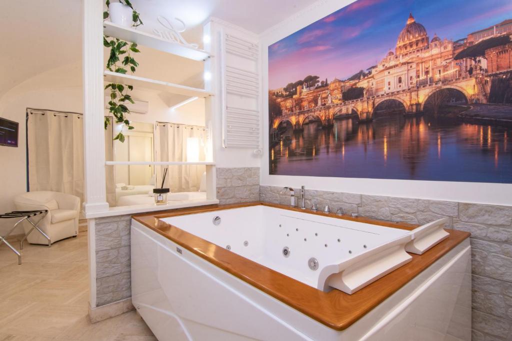 a bathroom with a bath tub with a painting on the wall at Deluxe Suite Welness in Rome