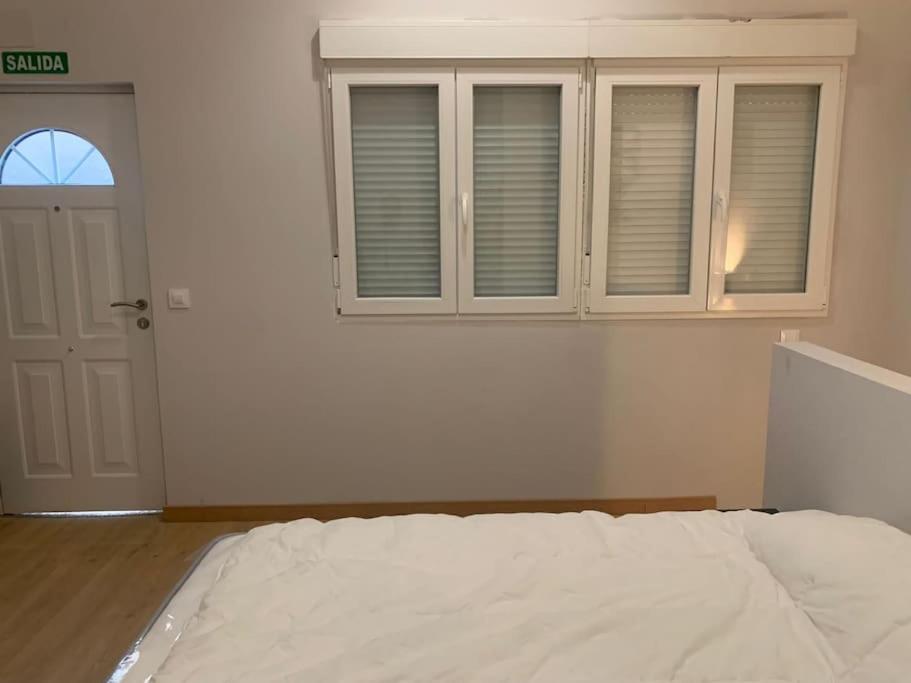 At 20' by Metro from the city centre (C) Apartamento en Av. América في مدريد: غرفة نوم بيضاء بها سرير ونافذة