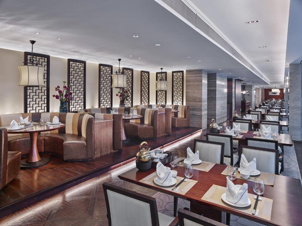 a restaurant with tables and couches and chairs at White Swan Hotel in Guangzhou