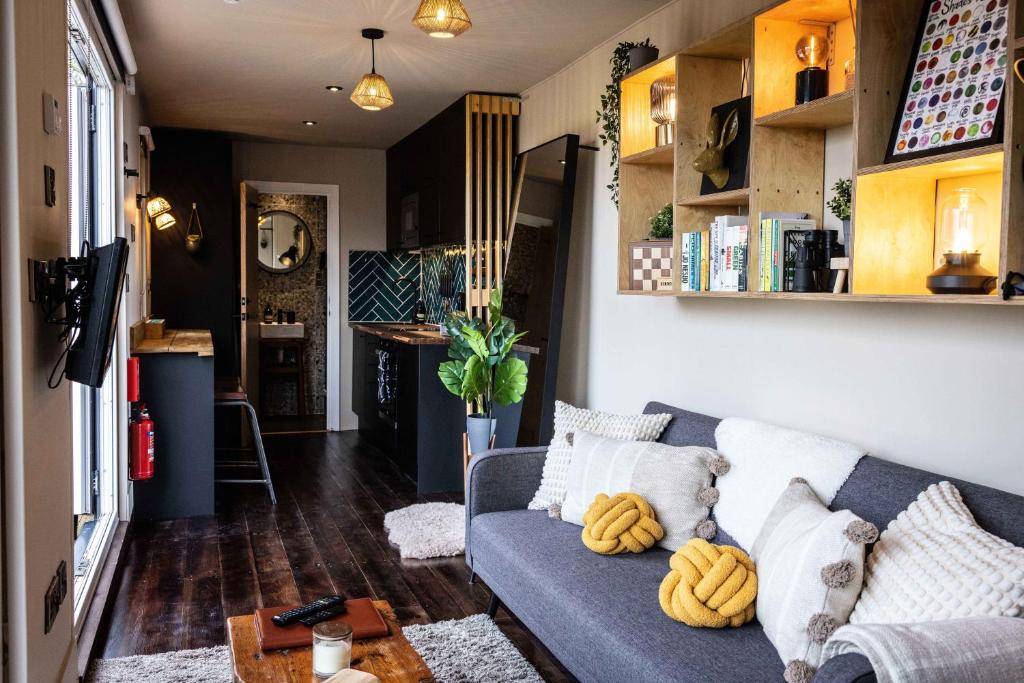 a living room with a blue couch and a table at The Hideaways in Exeter