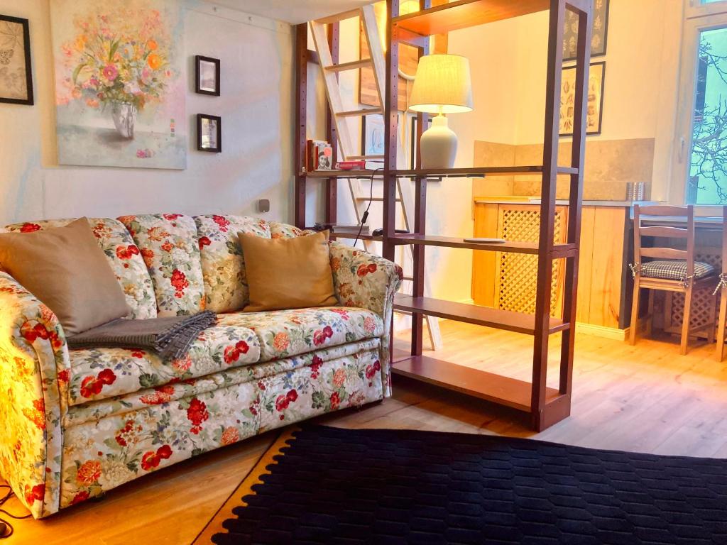 a living room with a couch and a table at Mini-Appartements am Burgberg in Bad Harzburg