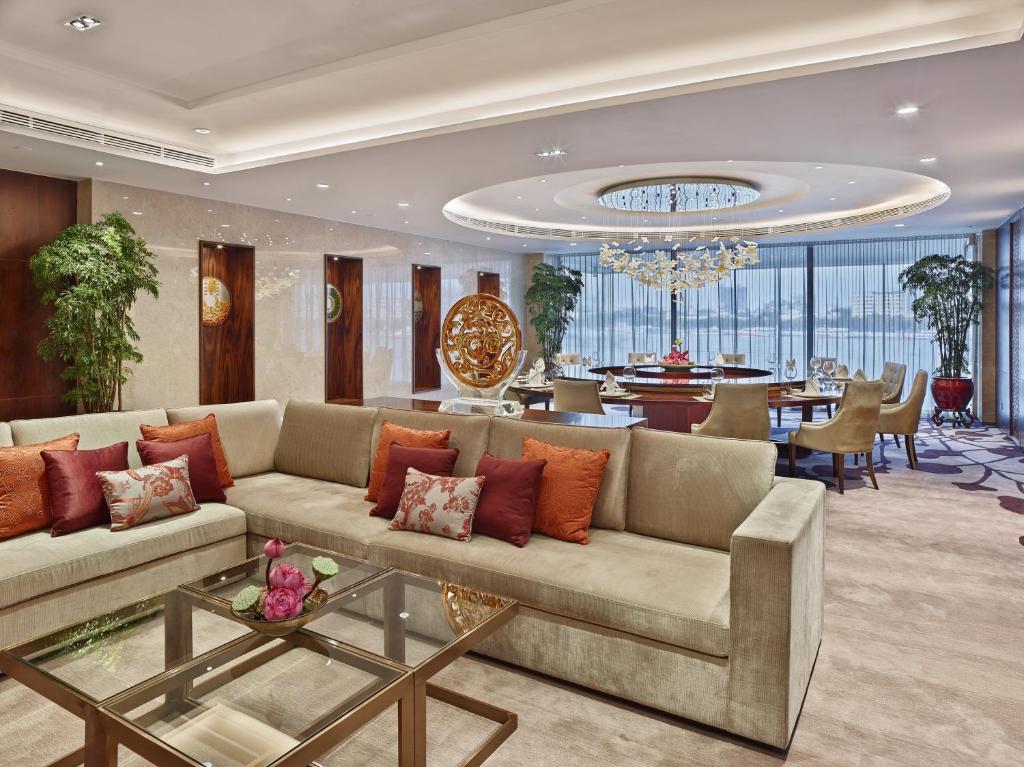 a living room with a couch and a dining room at White Swan Hotel in Guangzhou