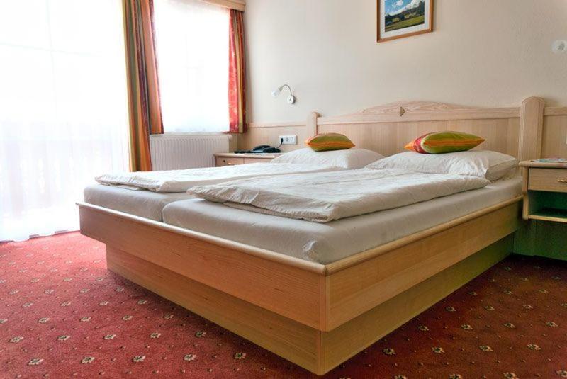 Postel nebo postele na pokoji v ubytování Alpengasthof Fichtenheim