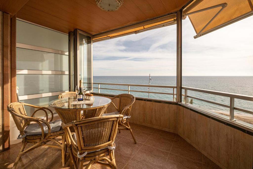 a balcony with a table and chairs and a view of the ocean at 3 bedrooms appartement at Calafell 5 m away from the beach with sea view terrace and wifi in Calafell