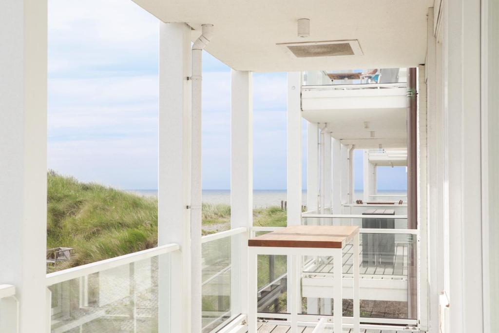 a balcony with a view of the ocean at Badhuis Dunes, Boulevard de Wielingen 2 in Cadzand
