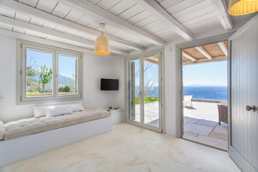 a living room with a couch and a view of the ocean at Island Villa Kon in Gavrio