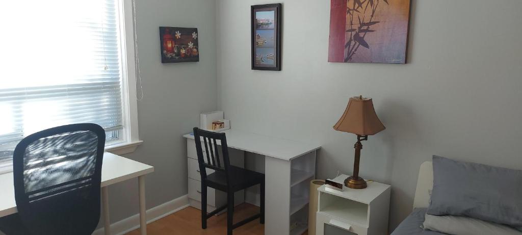 a room with a desk and a chair and a table at High Park Single room with exclusive washroom and kitchen for solo travelers in Toronto