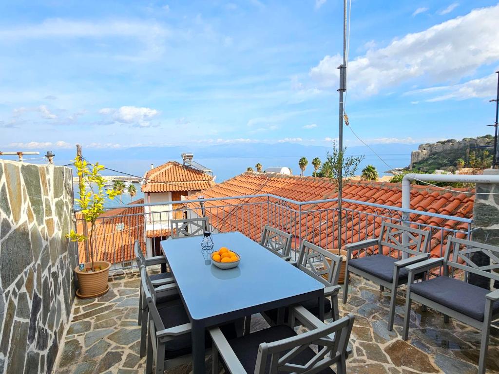 a table and chairs on a balcony with a view at Charites: Terrace with Seaview - 100m to the beach in Koroni